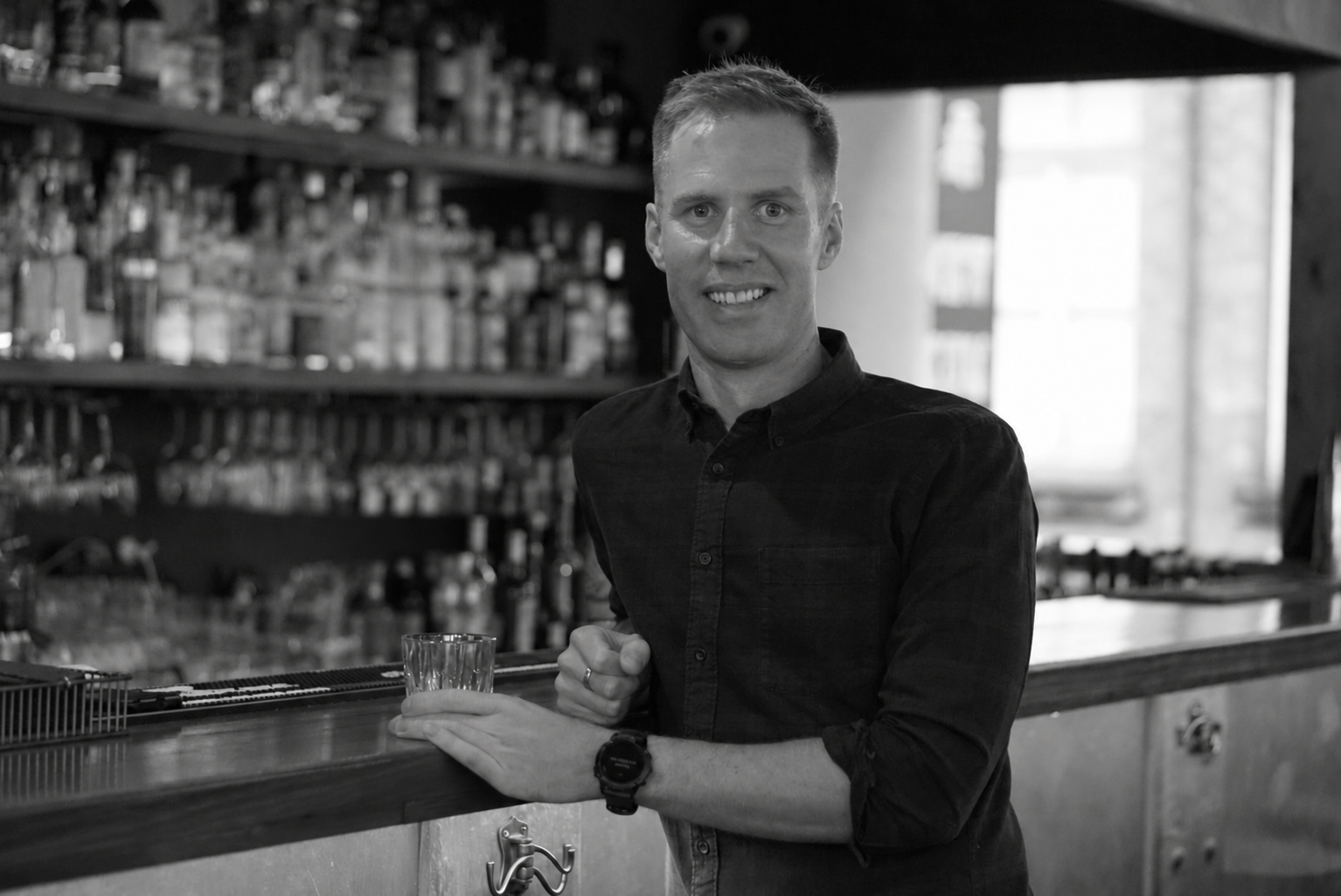 Dan Walker at the bar, in black and white