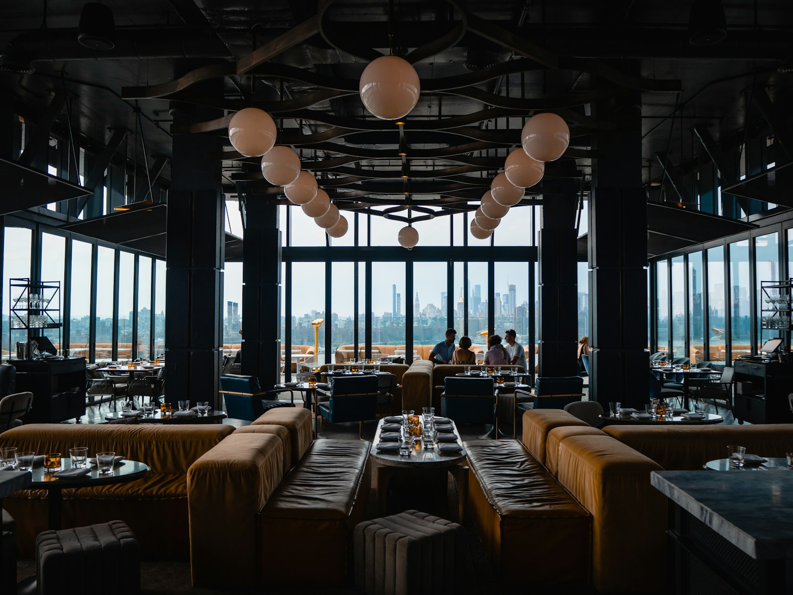 Restaurant dining room with curved booth seating and globe lighting